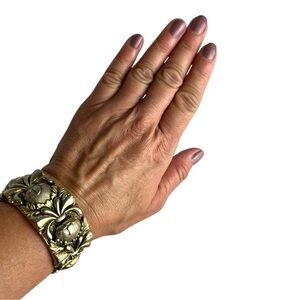 Ornate gold tone cuff bracelet